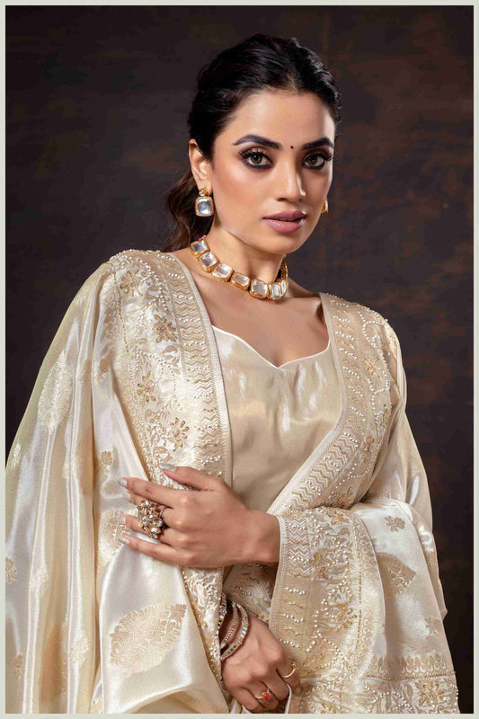 Off White Elegance: Tissue Silk Saree with Gold Zari Woven Details