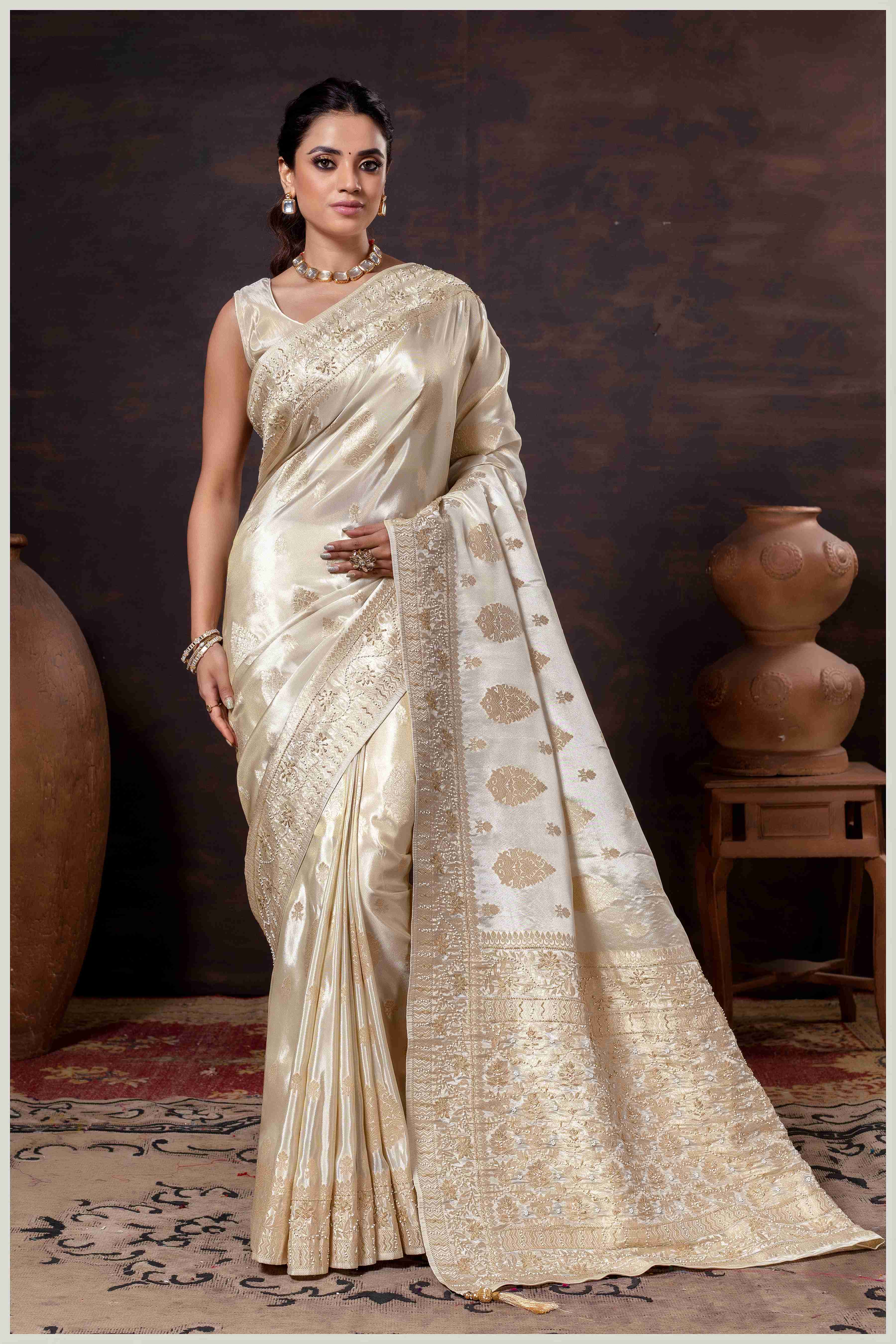 Off White Elegance: Tissue Silk Saree with Gold Zari Woven Details